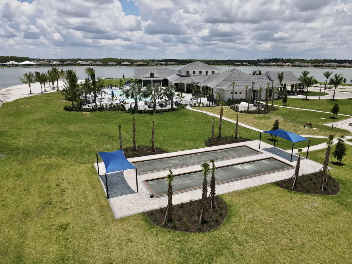 Shaded bocce courts beside the Social Club
