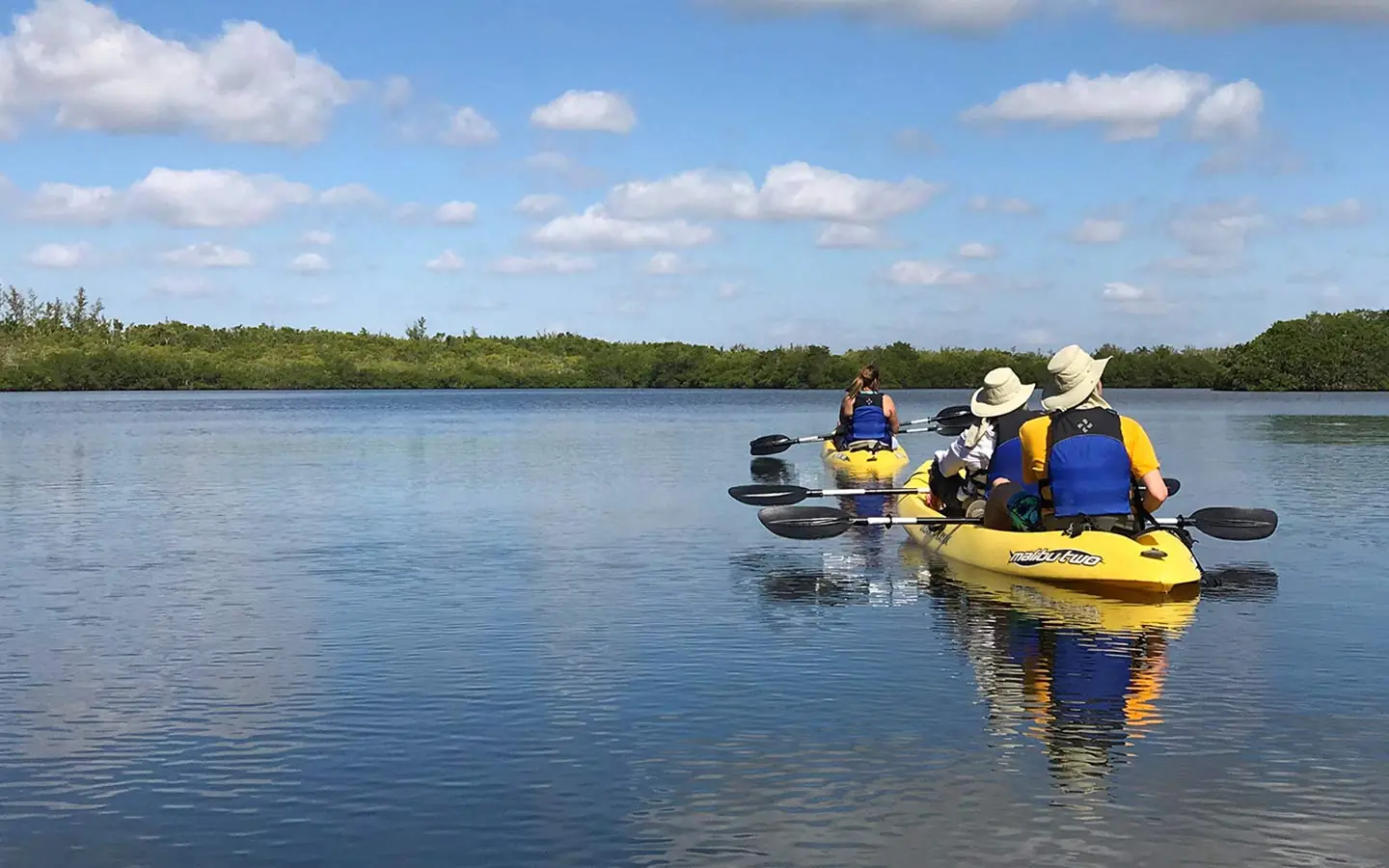 Two residents kayaking on a calm lake